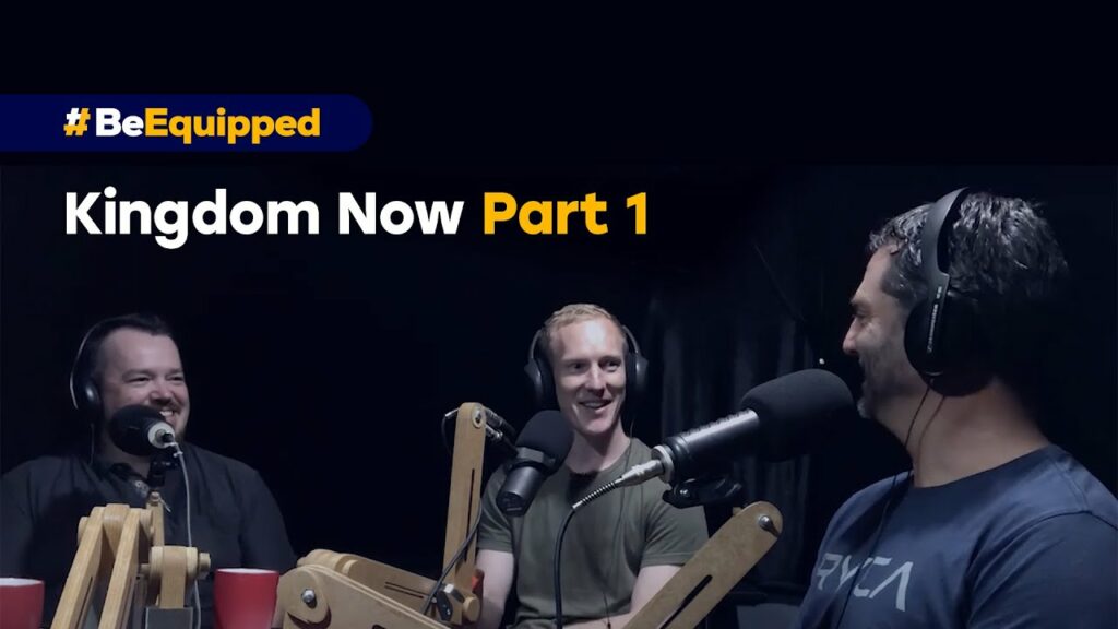Three speakers wearing headphones seated around a podcast table with microphones, on a banner reading ‘Kingdom Now Part 1’
