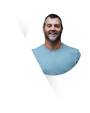 Head-and-shoulders portrait of Andrew Selley smiling, circular crop with diagonal white graphic overlay