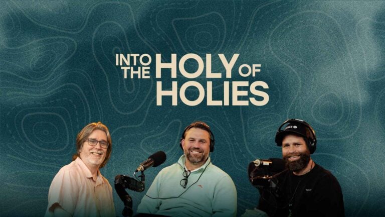Three speakers seated with microphones under the text "Into the Holy of Holies" on a teal patterned background