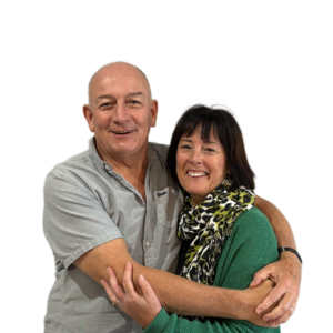 Andrew & Elizabeth East, smiling and embracing in a portrait