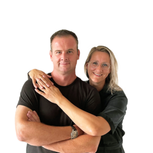 Peter & Eefje De Korte standing together, Eefje with arms around Peter