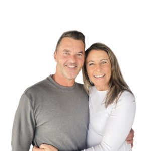 Waist-up portrait of Vincent & Christine Rafferty smiling and embracing