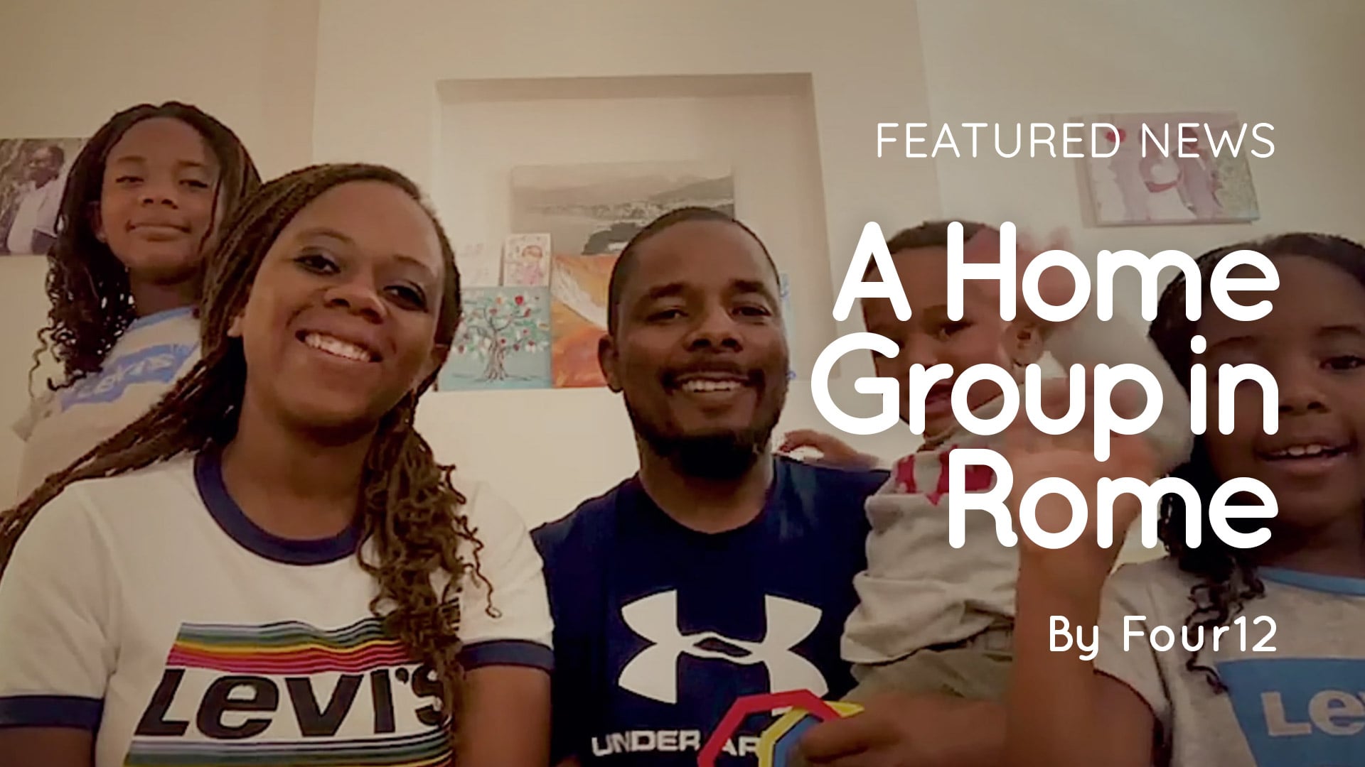 Bruce and Monica Nherera with their family sitting together in a living room in Rome, Italy