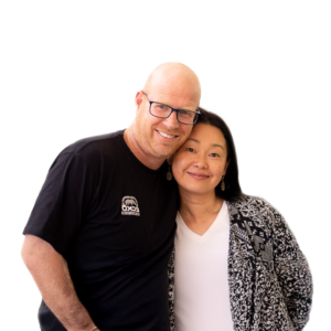 Carel & Naoko Albertyn smiling and standing close together, portrait photograph