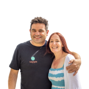 Portrait of Euan and Karen McRae smiling, standing close with his arm around her