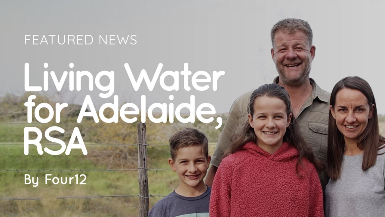 Four people (two adults and two children) smiling outdoors by a fence with overlaid title 'Living Water for Adelaide, RSA'