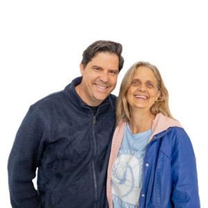 Michael & Adrienne d’Offay standing side by side, smiling at the camera