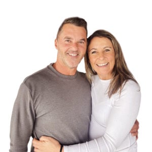Head-and-shoulders photo of Vincent Rafferty and Christine smiling and embracing against a white background