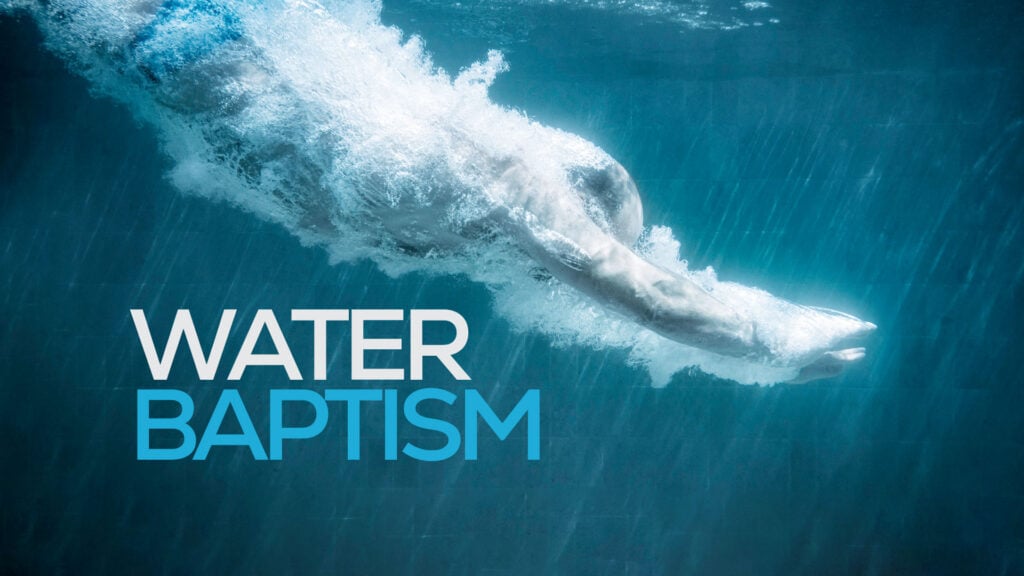 Underwater image of a person diving beneath the surface with the words "WATER BAPTISM"