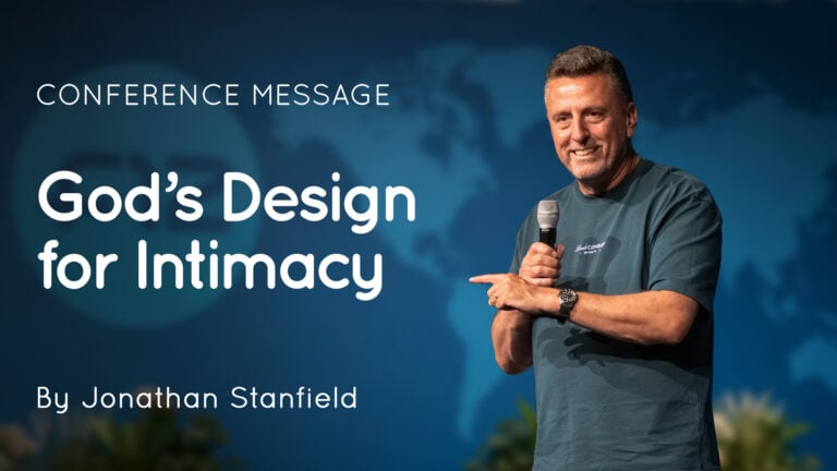 Jonathan Stanfield on stage holding a microphone and pointing, with a slide reading "God's Design for Intimacy"