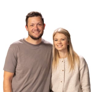 Daniel and Samantha Barnard smiling together against a white background