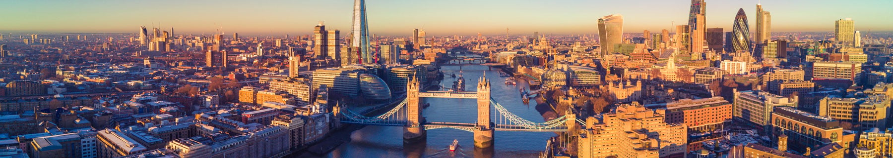 Panoramic aerial view of London showing the River Thames, Tower Bridge and the city skyline